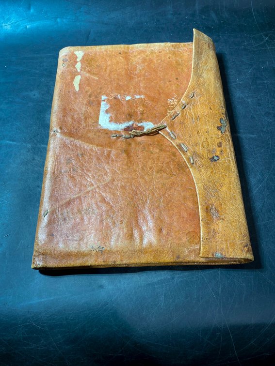 Leather-Bound Manuscript Document with Handwritten Text