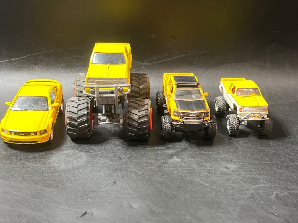 4 Die-Cast Yellow Toy Vehicles with Monster Trucks and Car
