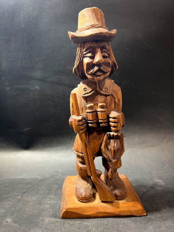 Hand-Carved Wooden Figurine of a Man with Rifle and Fish