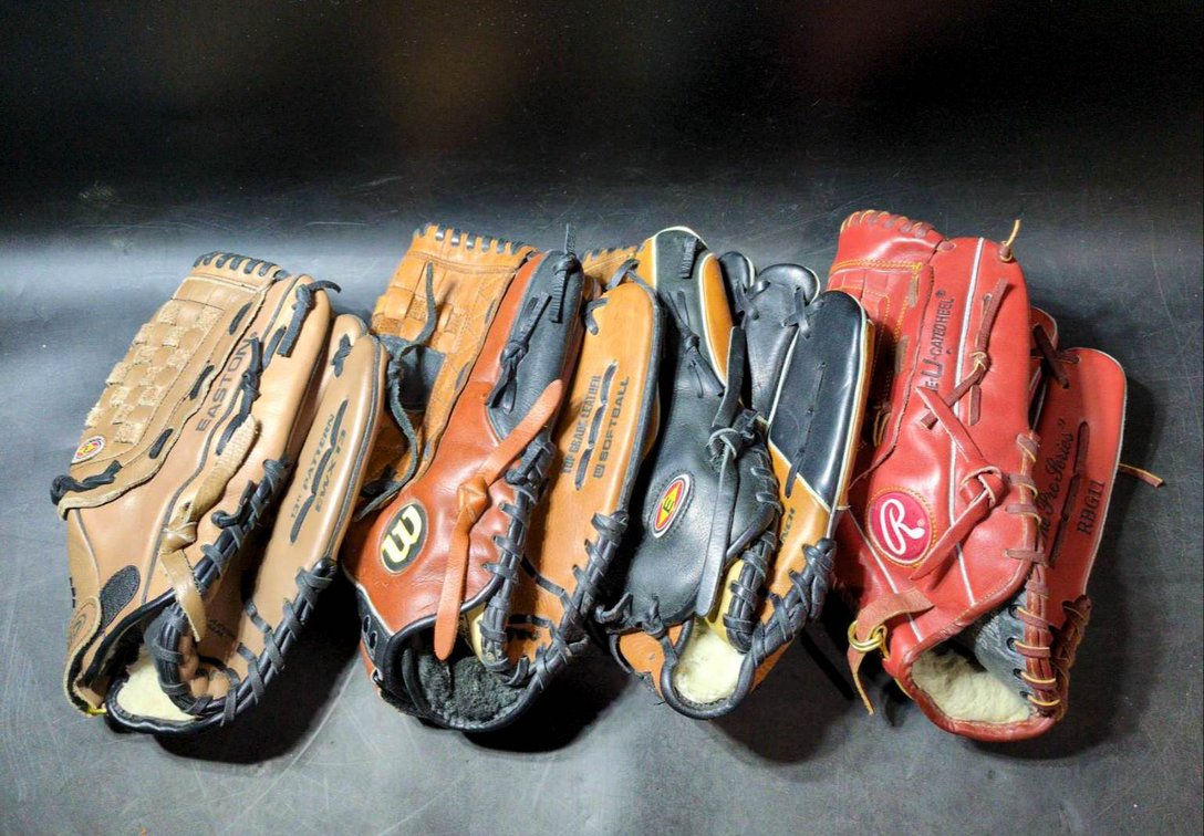 Four Baseball and Softball Gloves by Easton, Wilson, and Rawlings