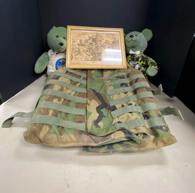 Military Woodland Camo Vest, Plush Bears, and Framed Battle Art