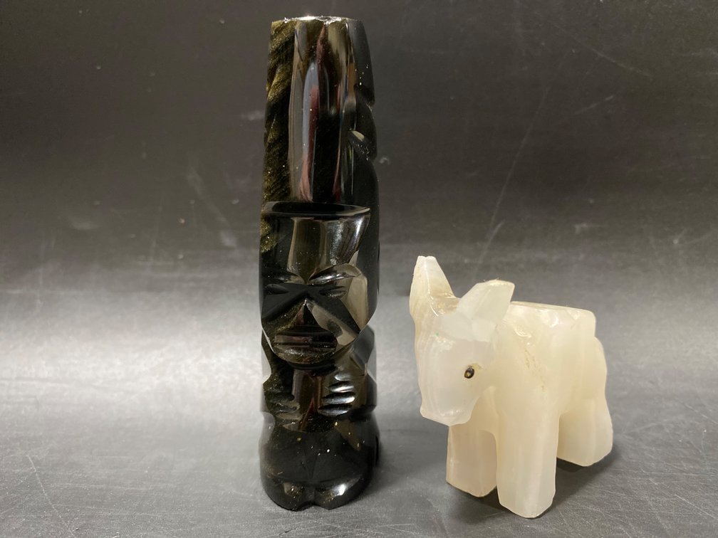 Two Carved Stone Figures: Black Totem Pole and White Animal Figurine