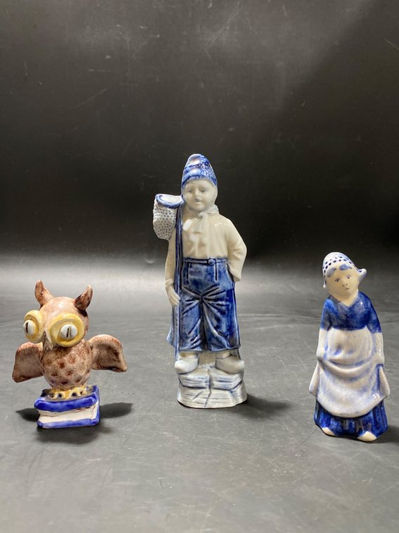 Three Ceramic Figurines: Boy with Fishing Net, Dutch Woman, and Owl