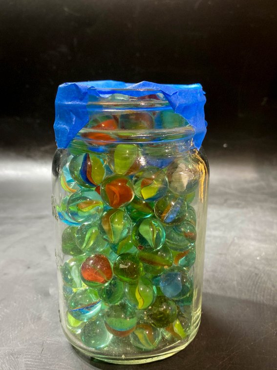 Glass Jar Filled With Multicolored Toy Marbles