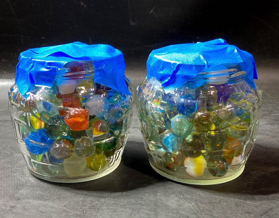 Two Glass Jars Filled with Assorted Colorful Marbles