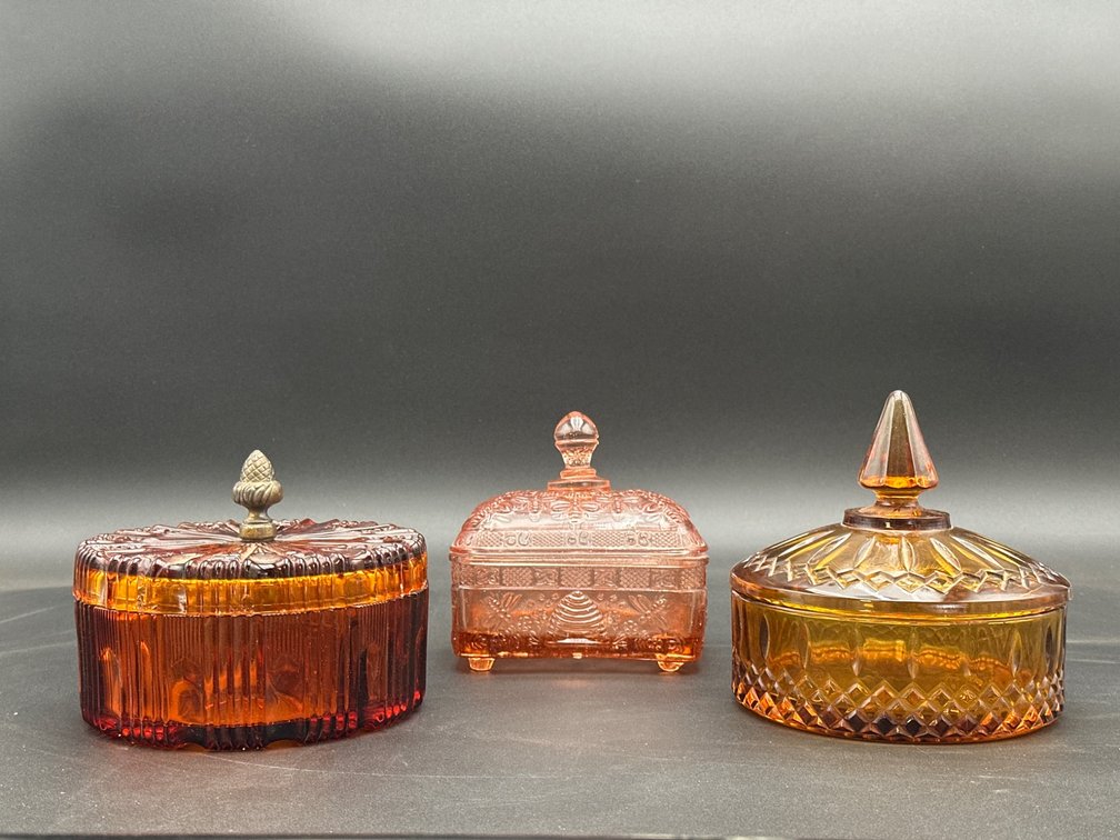 Three Amber and Pink Glass Lidded Candy Dishes with Decorative Finials