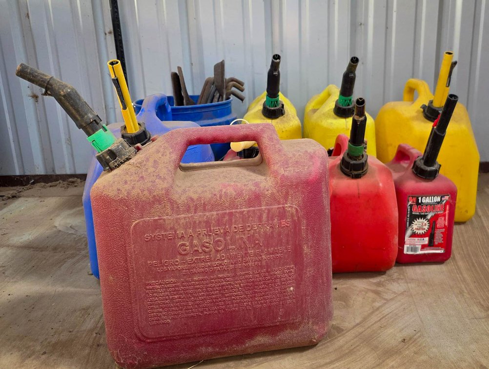 Plastic Fuel Containers and Metal Tools in Bucket