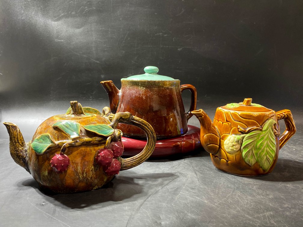 Three Ceramic Teapots and One Matching Base