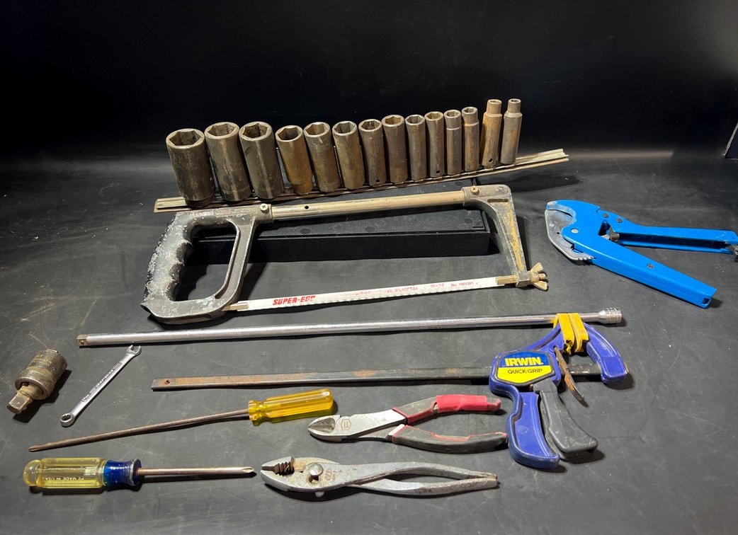 Hand Tools Including Sockets, Hacksaw, Pliers, and Screwdrivers