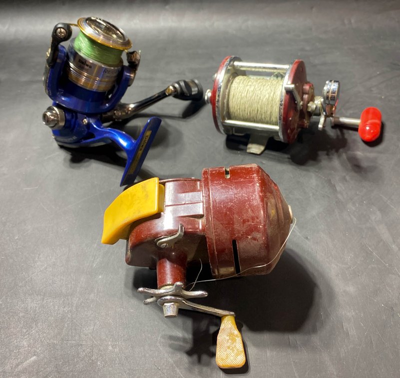 Three Fishing Reels Including Daiwa, Shakespeare, and Penn
