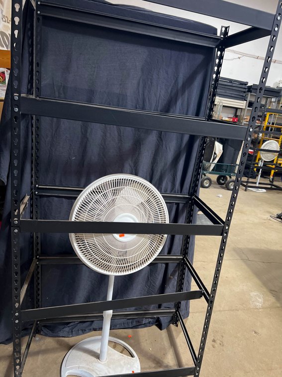 Black Metal Shelving Unit With Lasko Oscillating Fan