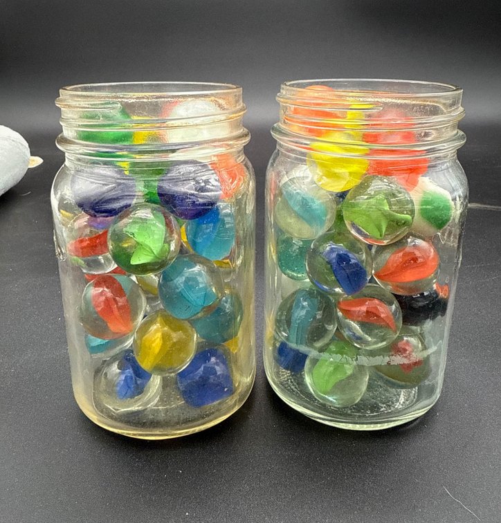 Two Glass Jars of Larger Glass Marbles