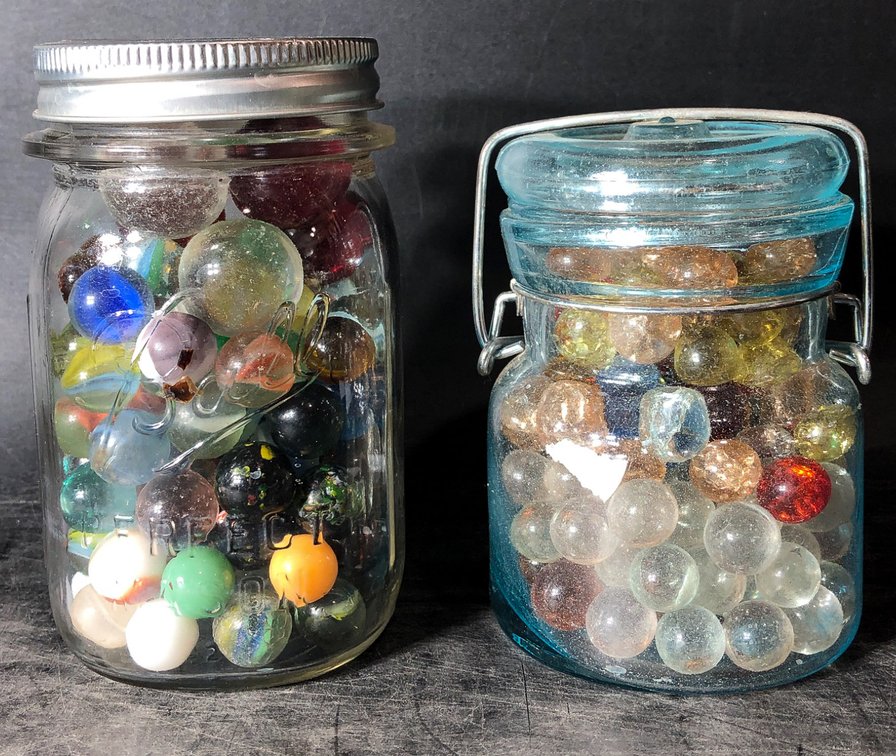 Two Jars Filled with Assorted Glass Marbles in Vintage Glass Containers