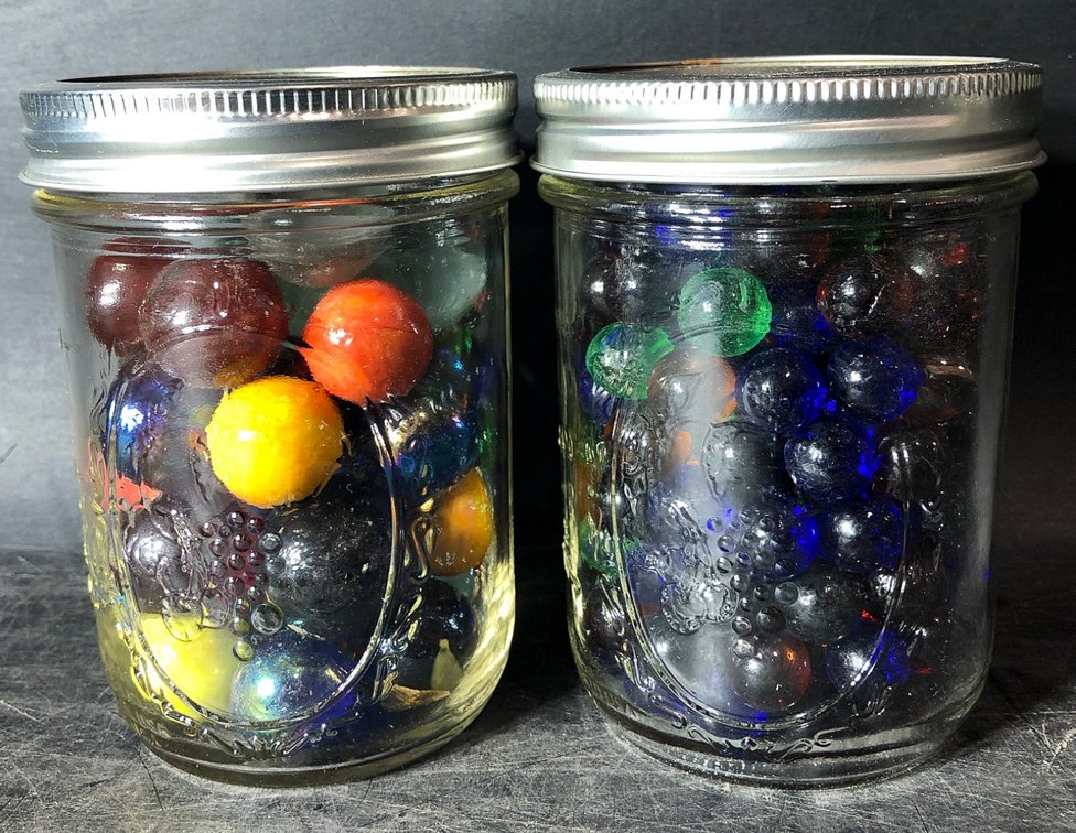 Two Mason Jars Filled With Assorted Color Glass Marbles