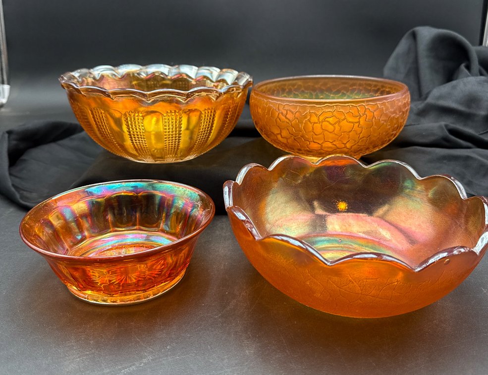 Four Amber-Colored Carnival Glass Bowls with Scalloped Edges