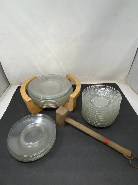 Clear Glass Plates with plate holder, a stack of side bowls, and wood mallet