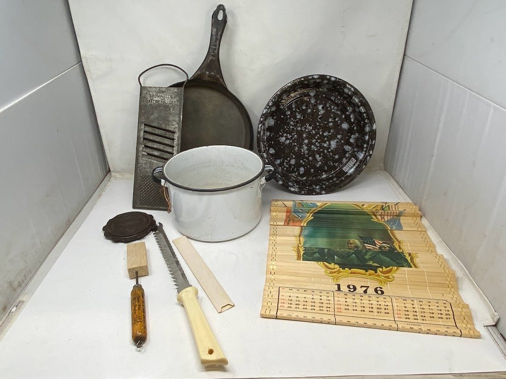 Group: Vintage 1976 Calendar, Graniteware pie plate, enamelware handle pot without lid, vintage cheese slicer, knife, Avery cast iron pot