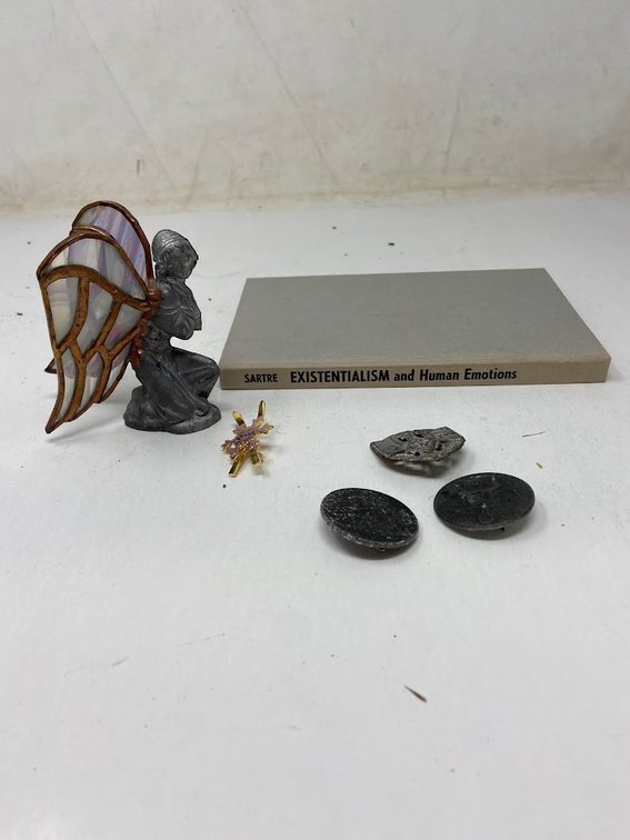 Third Reich Pins, angel decoration, and Existentialism and Human Emotions Book