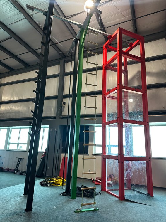 Indoor Climbing and Obstacle Course Structures with Red Enclosure and Ladder Features