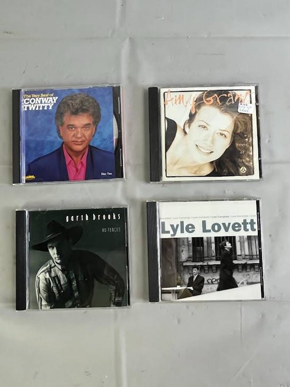 Four Music CDs: Conway Twitty, Amy Grant, Garth Brooks, and Lyle Lovett