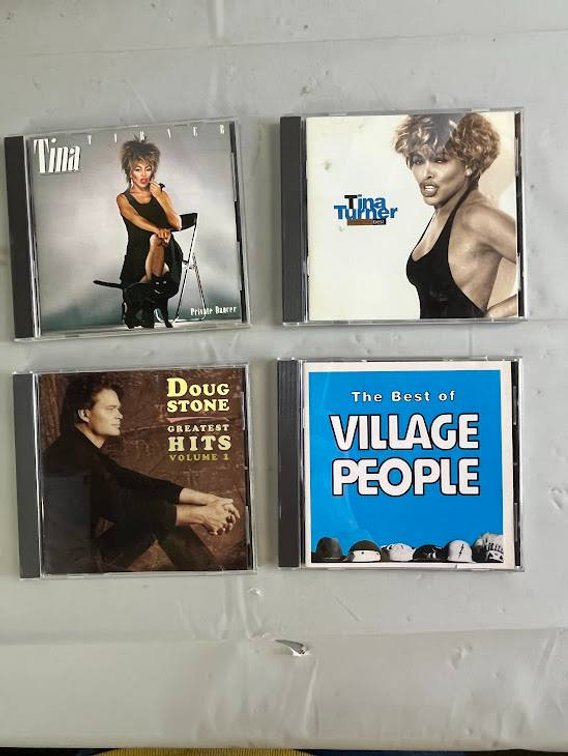 4 Music CDs Featuring Tina Turner, Doug Stone, and Village People