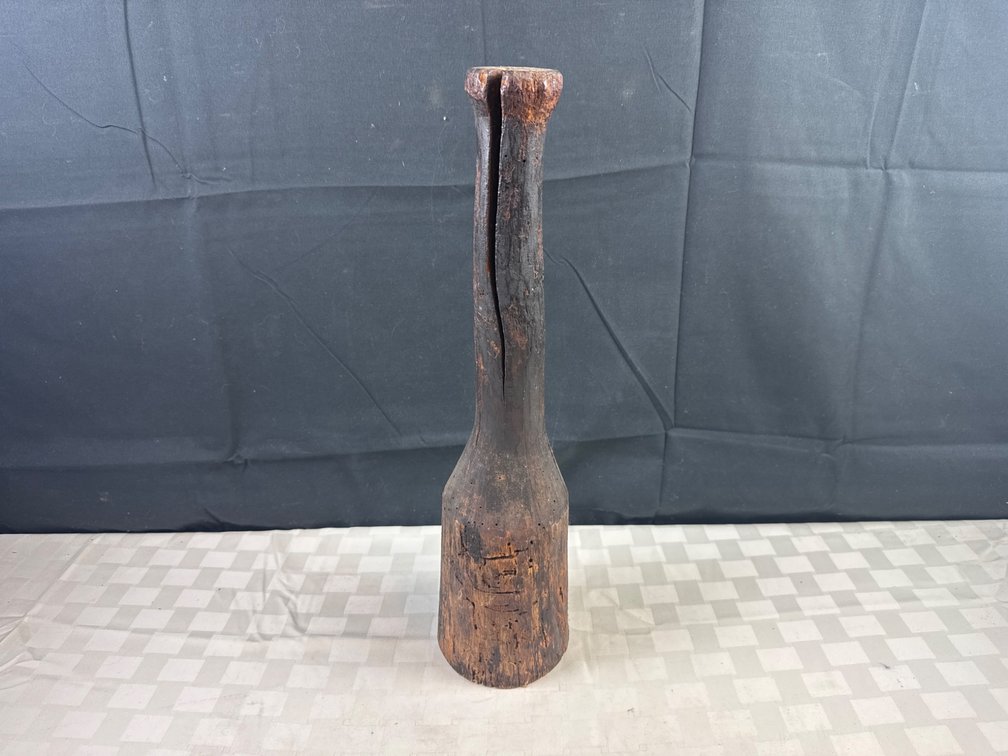 Hand-Carved Wooden Mallet with Visible Age Wear and Cracks