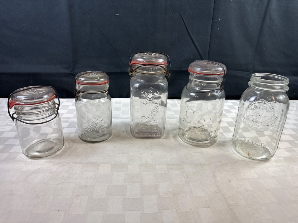 Five Vintage Glass Jars with Closures and Embossed Designs