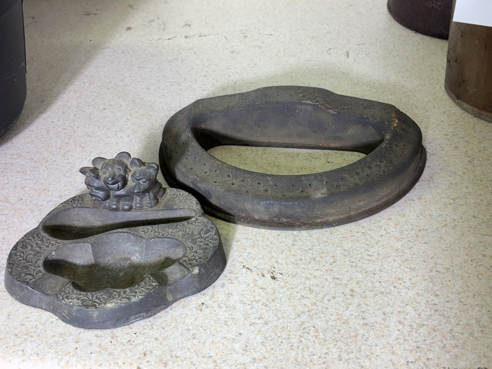 Two Cast Iron Molds, Cat and Oval Flower Shapes