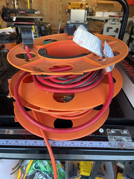 Three Orange Extension Cord Reels With Cords