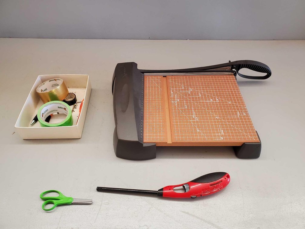 (I-18) PAPER CUTTER, LIGHTER, TAPE, AND MISC
