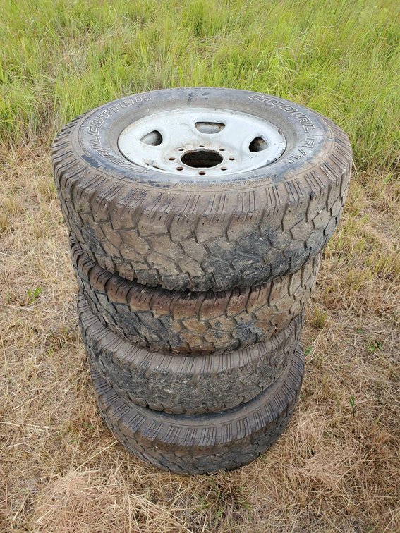 (I-63A) (4) TRAIL CUTTER TIRES, 265/75 R16 W/8 BOLT RIMS