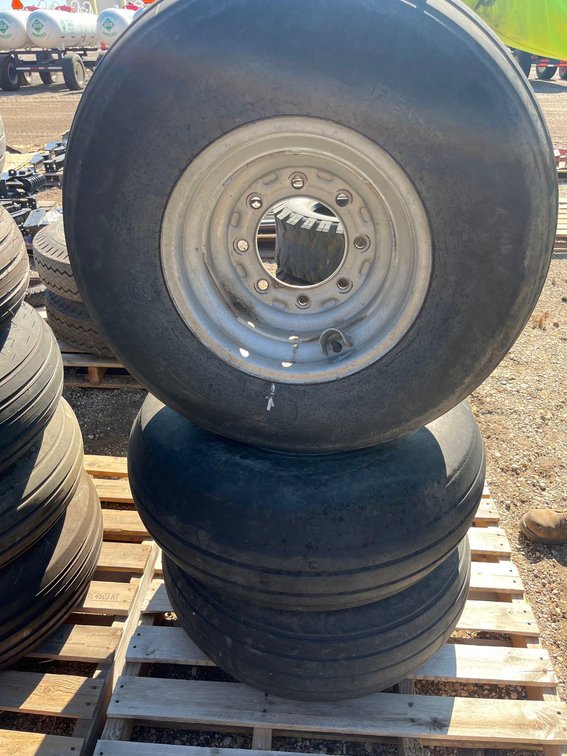 (B-245) (3) 12.5L-15 TIRES WITH 8 BOLT RIMS AND VALVE STEM PROTECTORS (ONE 6 BOLT RIM) 