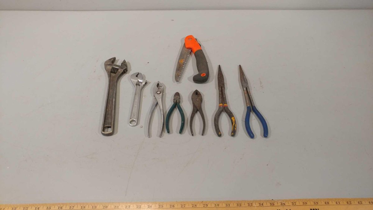 ASSORTMENT OF PLIERS, CRESCENT WRENCHES, FOLDING PRUNING SAW, AND OTHER MISC ITEMS