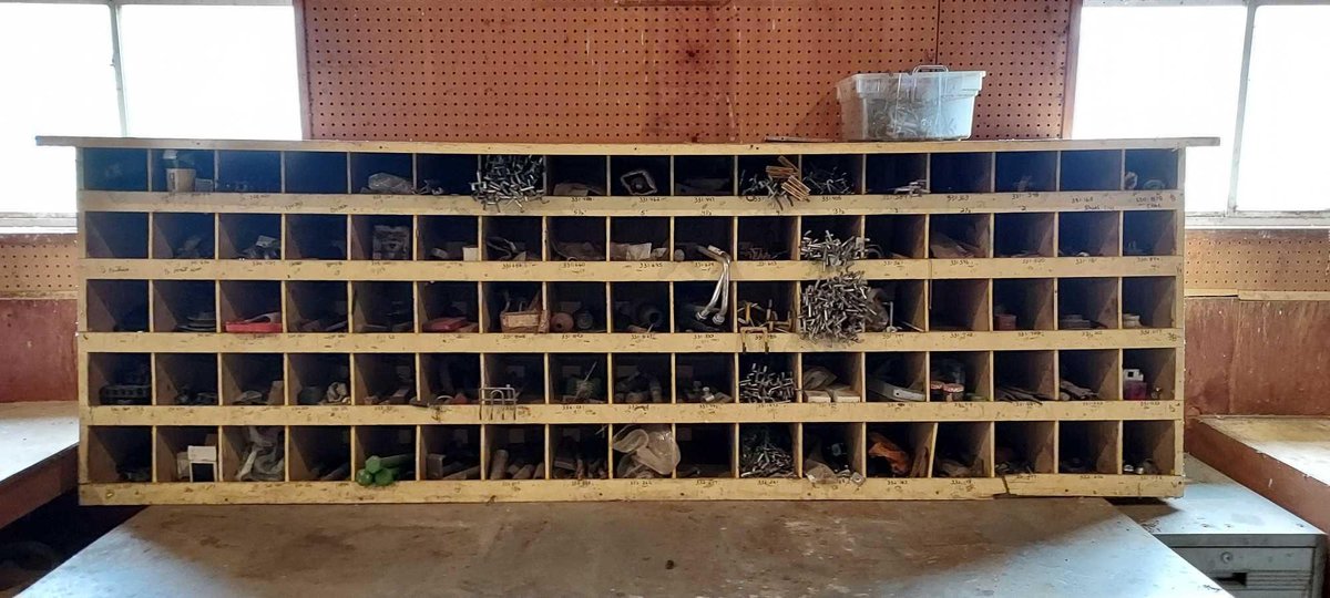 LARGE WOODEN BOLT BIN W/LARGE ASSORTMENT OF VARIOUS HARDWARE & MISC AND TABLE