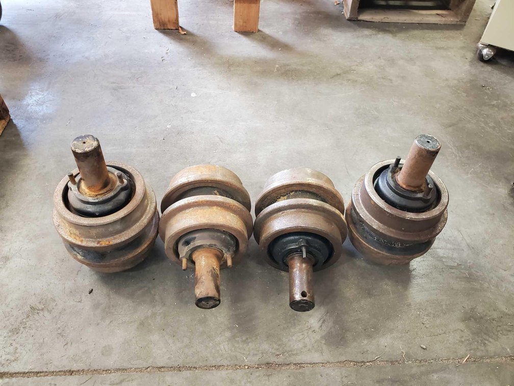 (I-11) (4) EXCAVATOR TOP CARRIER TRACK ROLLERS (FOR MORE INFO AND LOCATION CALL NEIL @ 612-804-4142)