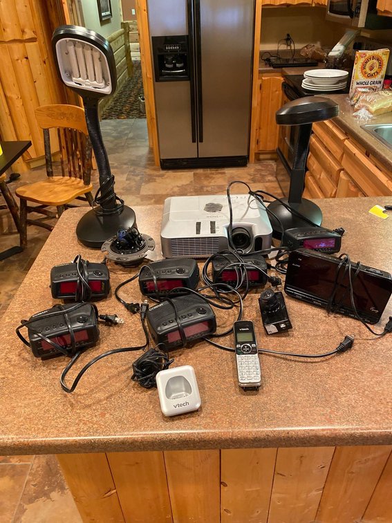 (A1-MANAGER) ASSORTMENT ALARM CLOCKS, PROJECTOR AND MISC ALL UNTESTED 