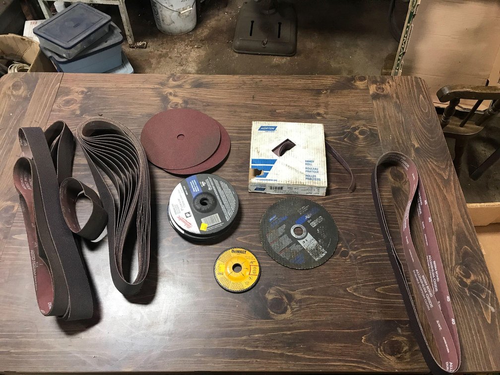 ASSORTMENT OF SANDPAPER, BELTS DISKS AND EMERY CLOTH , GRINDING DISKS