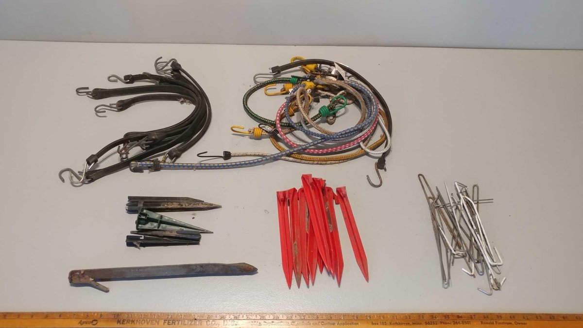 ASSORTMENT OF TENT STAKES AND BUNGEE CORDS