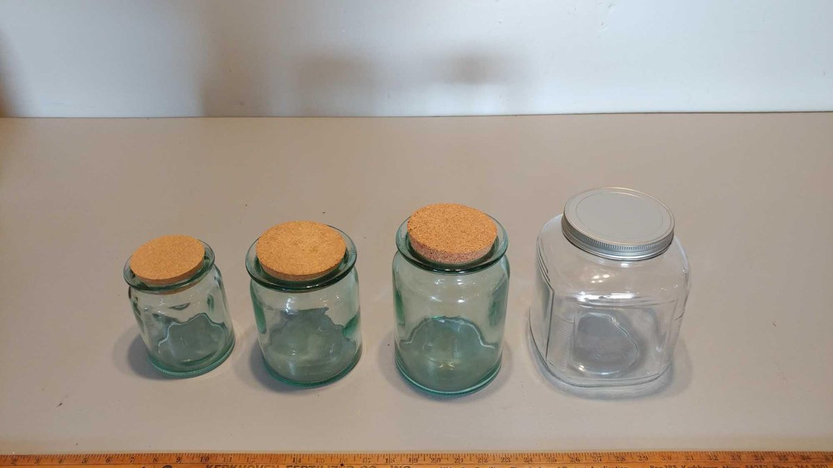 (3) CORKED DECORATIVE JARS (VARIOUS SIZES) & GLASS COOKIE CONTAINER WITH METAL COVER