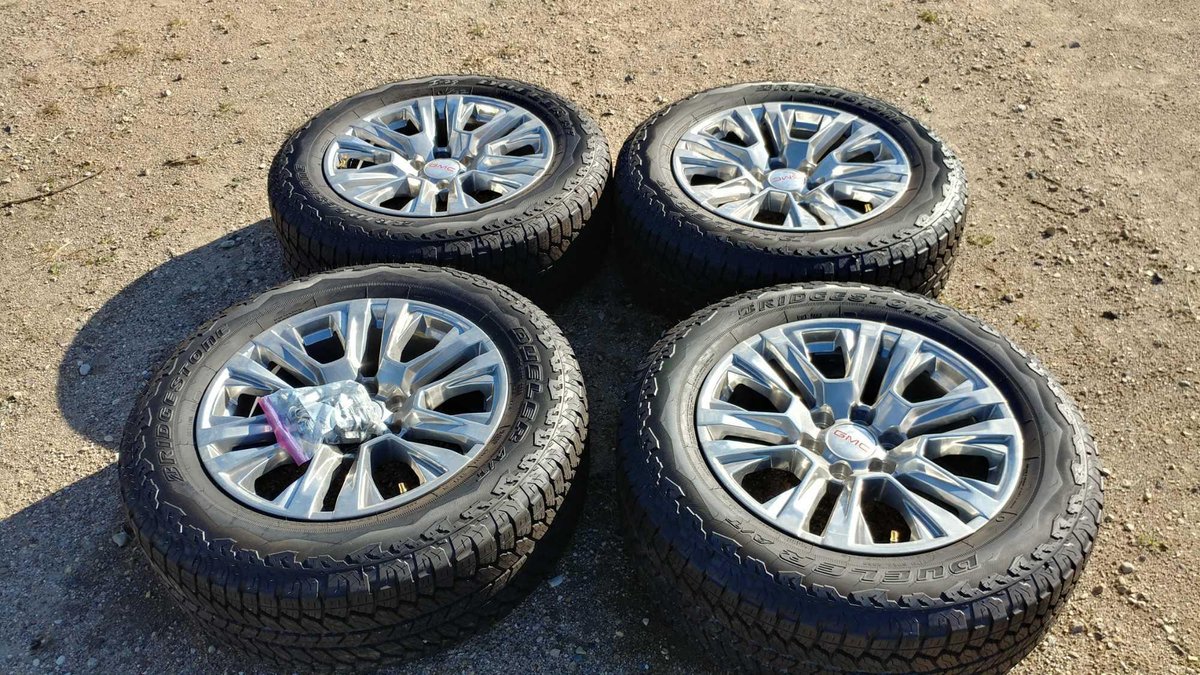 (I-28) (4) BRIDGESTONE DUELER A/T 275/60 R20 APPROX. 11/32 TREAD TIRES W/ (4) 20" CHROME ALUM GMC RIMS (FITS GM '88 AND UP)