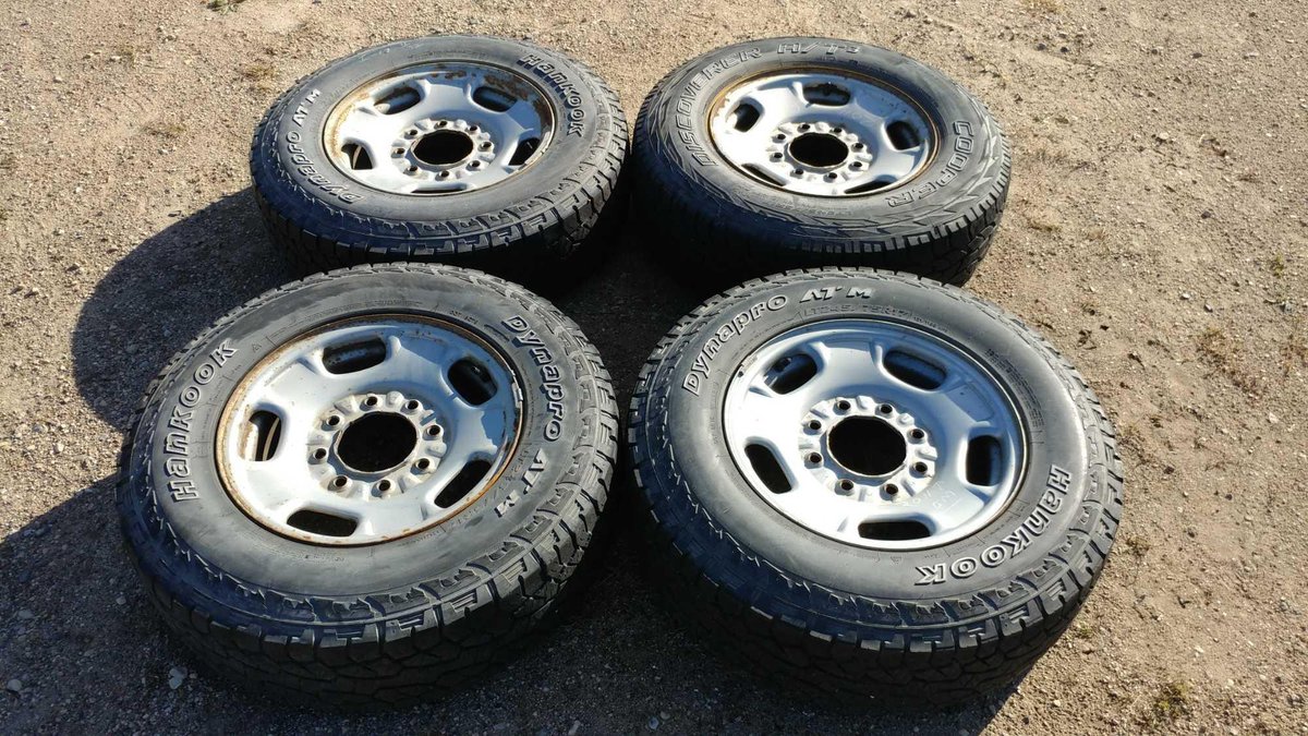 (I-17) (4) HANKOOK DYNAPRO ATM LT245/75 R17 APPROX. 11/32 TREAD TIRES W/ (4) STEEL RIMS (FITS GM '11 AND UP)