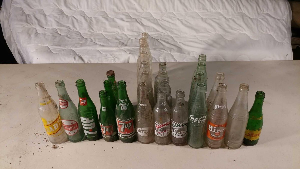 ASSORTMENT OF VINTAGE SODA BOTTLES OF VARIOUS KINDS