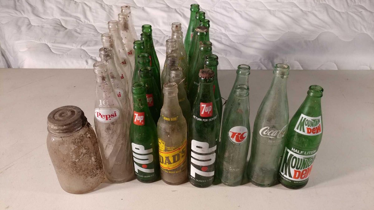 ASSORTMENT OF VINTAGE SODA BOTTLES OF VARIOUS KINDS