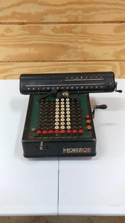 ADDING MACHINE / CALCULATOR. A LARGE BLACK ADDING MACHINE MADE BY THE MONROE CALCULATING COMPANY. IT