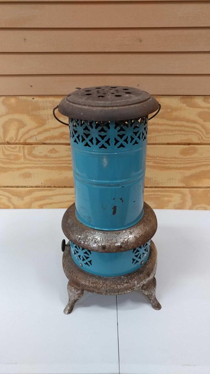 THIS KEROSENE SMOKELESS ROOM HEATER HAS BLUE ENAMEL BASE COLORING. IT IS TWO FEET TALL AND STANDS ON