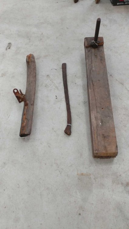 LARGE WOODEN CLAMP W/HINGE ON ONE SIDE AND LARGE SCREW ON THE OTHER END, AX HANDLE AND OLD RUDDER.