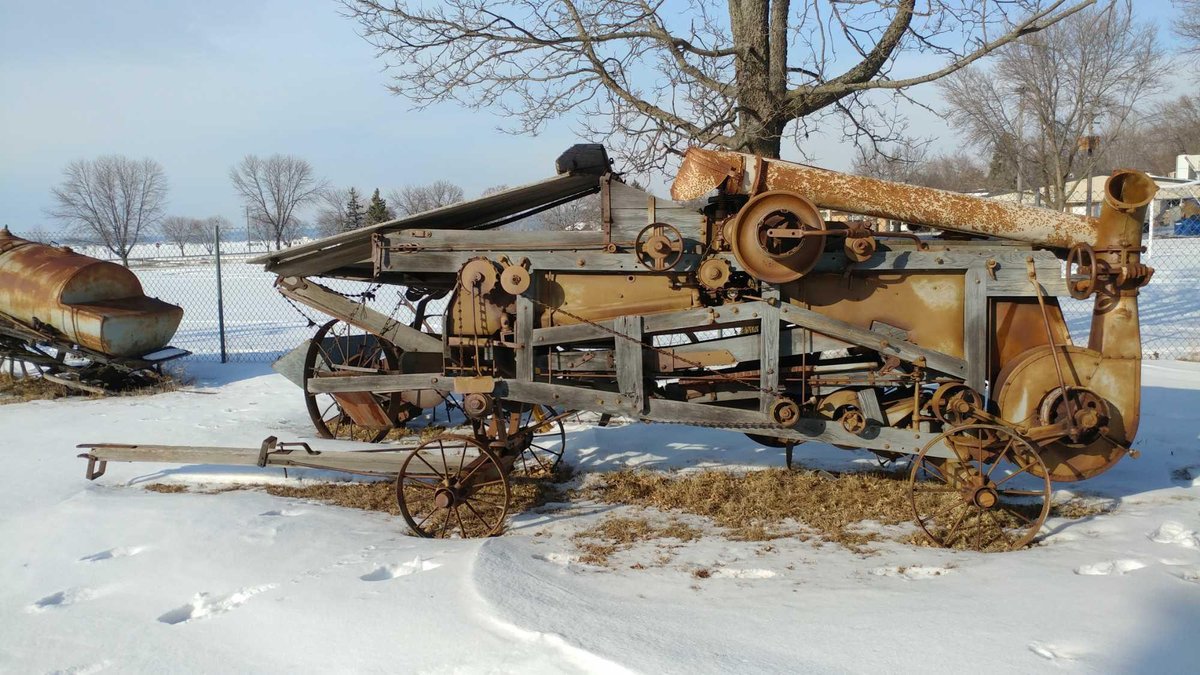 THRESHING MACHINE. 19.5 FEET LONG. IT IS PAINTED GRAY. IT WAS ORIGINALLY BLACK.