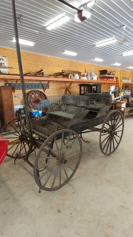 WAGON BOX / BUCKBOARD. FROM ETHEL RUNDQUIST. THERE ARE 2 SEATS, A COVER AND WHEELS.