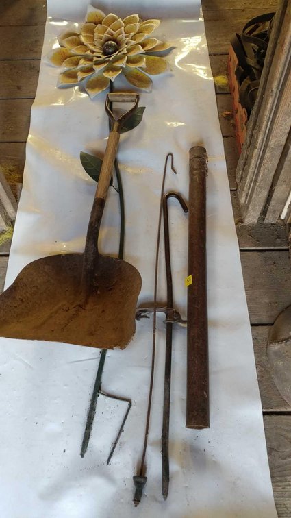 (A) POST POUNDER, SHOVEL, FENCE STRETCHER, AND GARDEN FLOWER 