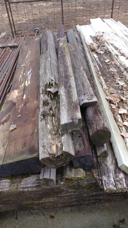 ASSORTMENT OF TREATED WOOD FENCE POSTS AND VARIOUS BOARDS